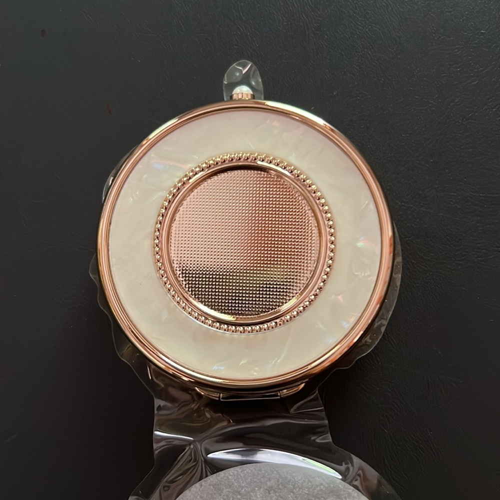Compact Mirror Gold with pearl clasp. ~2” diameter